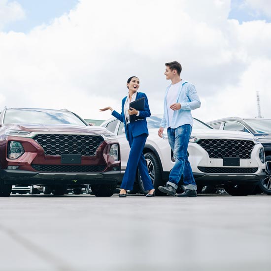 Auto saleswoman with customer